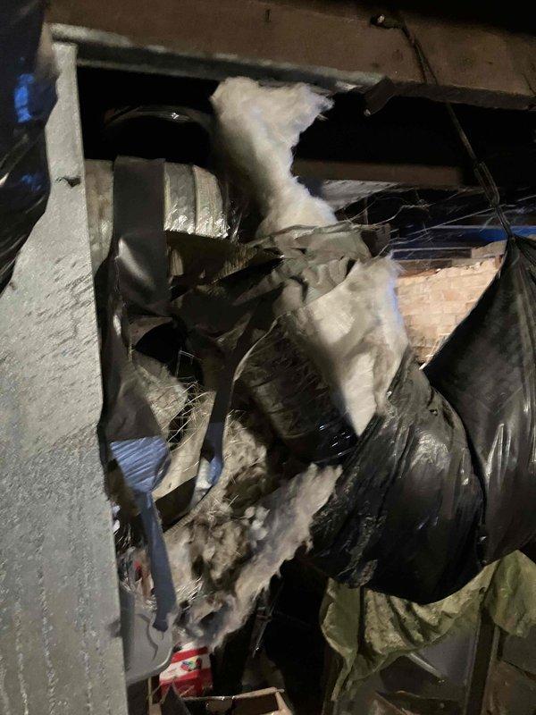 During inspection, found furnace inoperable with tripped upper rollout switch. Upon reset and operation, observed heavy flames with significant orange coloration. Examination revealed multiple cracks and voids in heat exchanger, rendering the system unsafe. Documented damaged ductwork with torn insulation and compromised connections. Unit requires immediate replacement for safety compliance.