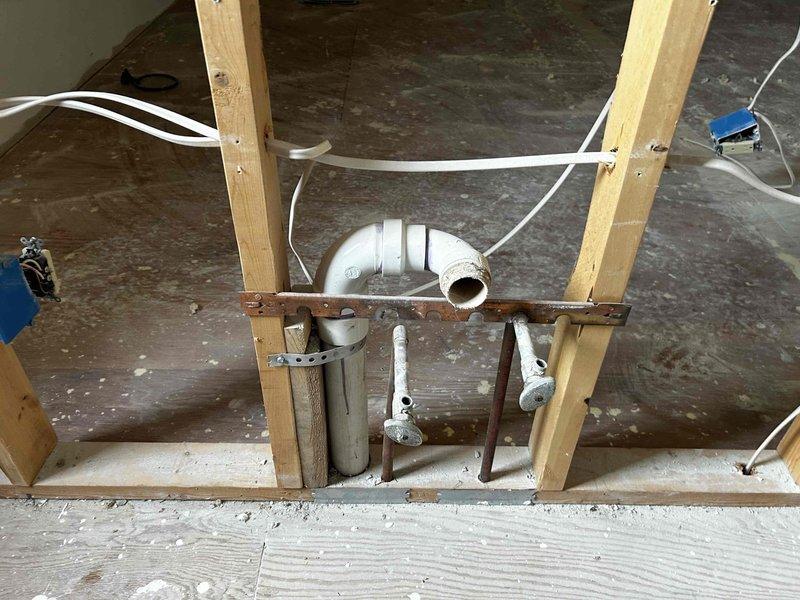 Conducted on-site assessment for plumbing estimate regarding steam shower installation and general replumbing requirements. Inspected exposed wall structures with existing insulation, vapor barriers, and current PVC drain/vent pipe configuration. Evaluated rough-in plumbing needs and identified necessary modifications to accommodate requested steam shower installation.