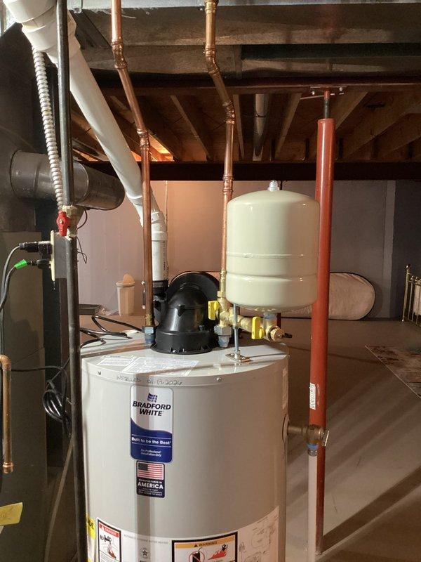 Successfully installed a new Bradford White water heater according to the approved estimate. Installation included proper connection of all copper and PVC piping, mounting of an expansion tank, and installation of appropriate shut-off valves. System was verified to be in good working condition with no leaks.