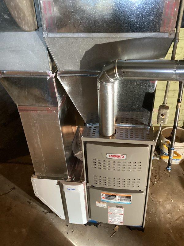 Installed new Lennox ML180UH090E48B furnace with T4 thermostat, 1620 media filter, and connected to existing venting system for immediate heat restoration. Chimney liner installation scheduled pending favorable weather conditions. Complete system includes properly secured metal ductwork with sealed joints and connections to ensure optimal performance.