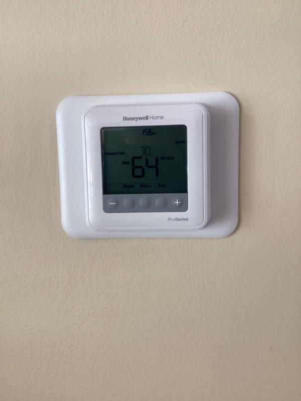 Successfully installed Honeywell Home ProSeries T-6 programmable thermostat after multiple rescheduled appointments. Completed proper wiring connections to the HVAC system and confirmed unit is functioning correctly with heat setting at 64°F.