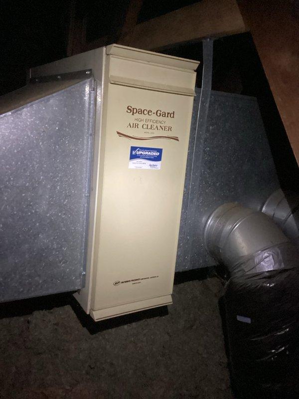 Responded to callback to secure HVAC system components. Installed Space-Gard High Efficiency Air Cleaner unit, properly connecting it to existing ductwork and drainage system. Removed and disposed of the old filter assembly as requested, and documented the completed installation with verification photos.