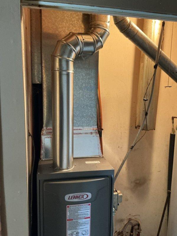 Successfully installed a Lennox ML180DF045E36AK furnace with T4 thermostat per customer specifications. Reconnected unit to existing return filter duct, replaced 1" filter, and verified proper system operation. Installation includes appropriate metal ductwork connections and exhaust venting.