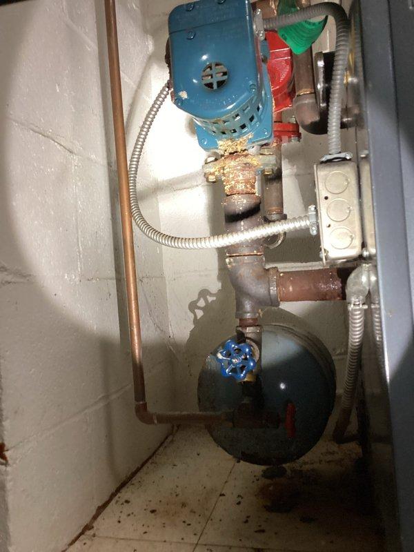 Responded to no-heat call at residence with 30+ year old system. Upon inspection, discovered the aging hydronic heating system with significant corrosion at pipe connections and deteriorating components. Identified failed circulator pump as primary issue and replaced pump to restore proper operation. System now functioning correctly with adequate heat distribution throughout home.