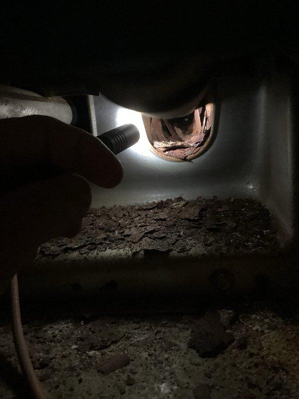 Responded to customer complaint of insufficient heating and burning odor from an aging furnace that was running continuously without reaching setpoint. Inspection revealed significant dust and debris accumulation inside unit with signs of corrosion on copper fittings. Cleaned accumulated debris, inspected connections, and addressed corrosion issues to restore proper system operation and eliminate burning smell.