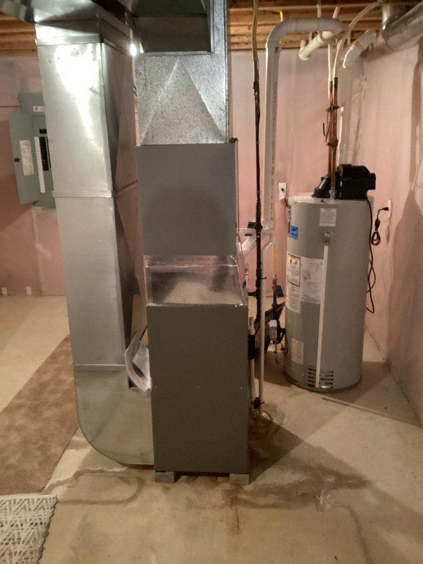 Successfully installed new Lennox ML196UH070XE48BK furnace with T4 thermostat in basement utility room, connecting to existing filter return. System startup performed with temperature verification confirming proper operation at 35.6°F.