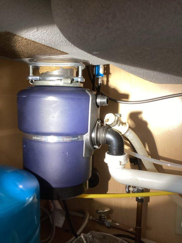 Responded to service call for reported dishwasher drain leak and heating concerns. Upon inspection, identified and reconnected loose drain line connection between dishwasher and InSinkErator Evolution SpaceSaver disposal unit. Confirmed proper drainage and verified no active leaks in the system after repair.