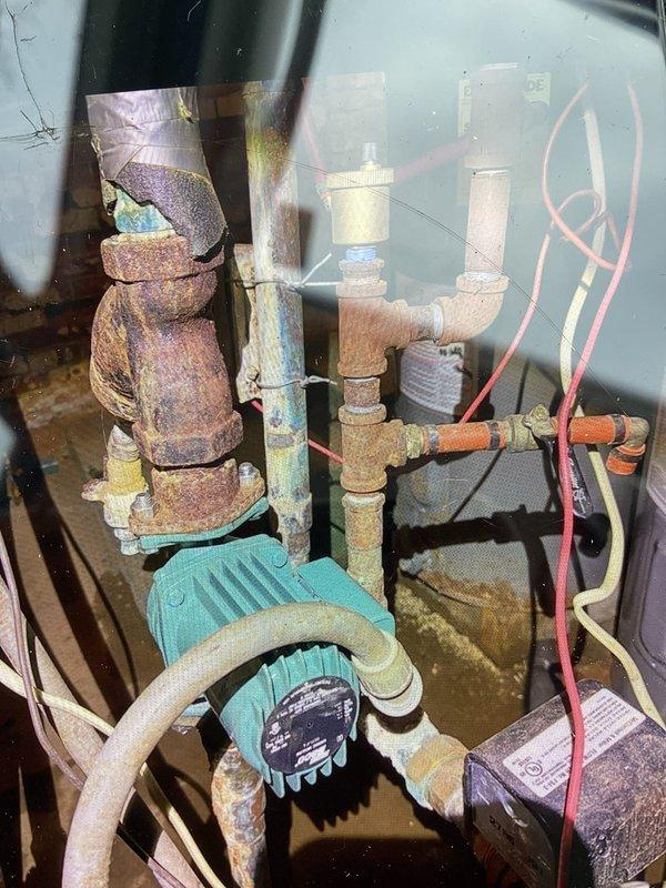 Responded to service call regarding circulation system issues. Retrieved necessary parts (circulator and auto vent) from Midcity using PO #402866345-001. Installed new turquoise water circulation pump to replace corroded unit, addressing significant oxidation observed throughout copper piping system. System pressure confirmed at approximately 15-16 PSI post-repair, within normal operating parameters.