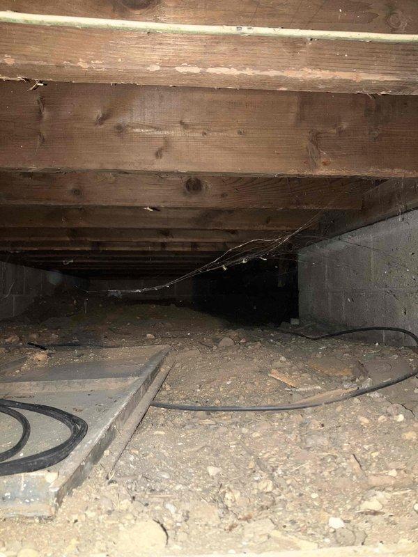 Conducted comprehensive assessment for two separate quotations: 1) Relocation of kitchen register currently positioned where new dishwasher installation is planned, and 2) Complete HVAC system replacement evaluation. Inspection revealed significantly aged existing HVAC equipment approaching end of service life. Crawlspace examination showed limited access conditions with exposed wooden joists showing signs of weathering. Customer interested in financing options for the system replacement.