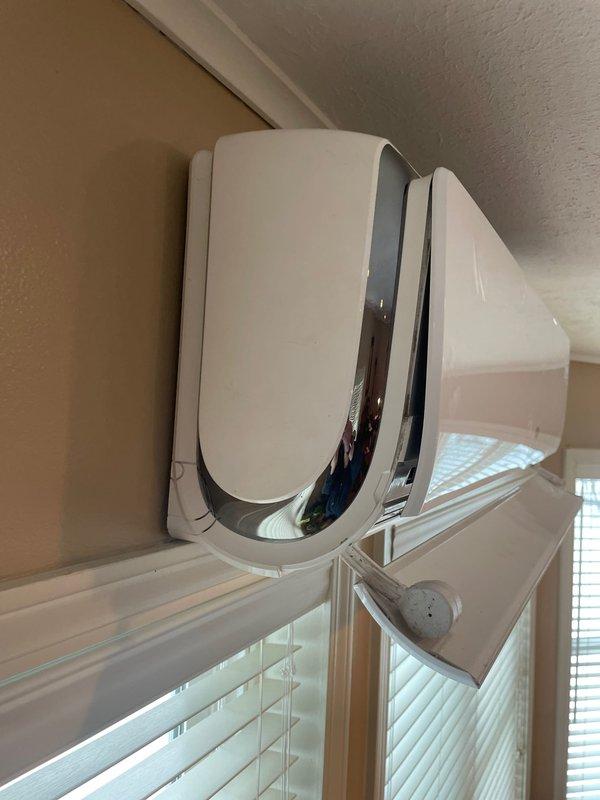 Conducted comprehensive evaluation of existing mini-split system installed in 2015 for potential replacement. Inspection revealed weathered exterior wall penetration with visible moisture damage and deterioration around line set penetration. Interior unit appears functional but aging, mounted on beige wall above window. Customer expressed interest in exploring replacement options including potential financing solutions.