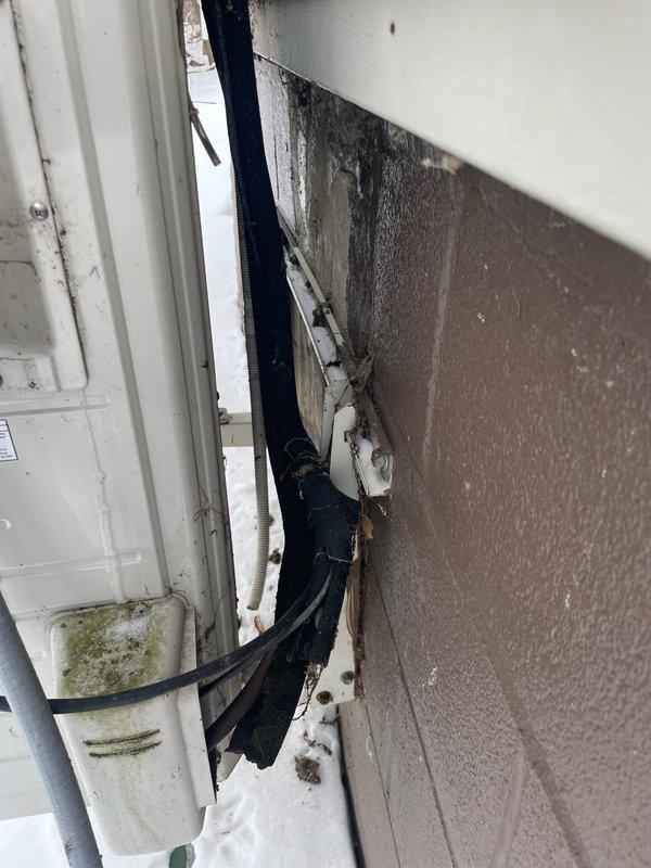 Conducted comprehensive evaluation of existing mini-split system installed in 2015 for potential replacement. Inspection revealed weathered exterior wall penetration with visible moisture damage and deterioration around line set penetration. Interior unit appears functional but aging, mounted on beige wall above window. Customer expressed interest in exploring replacement options including potential financing solutions.