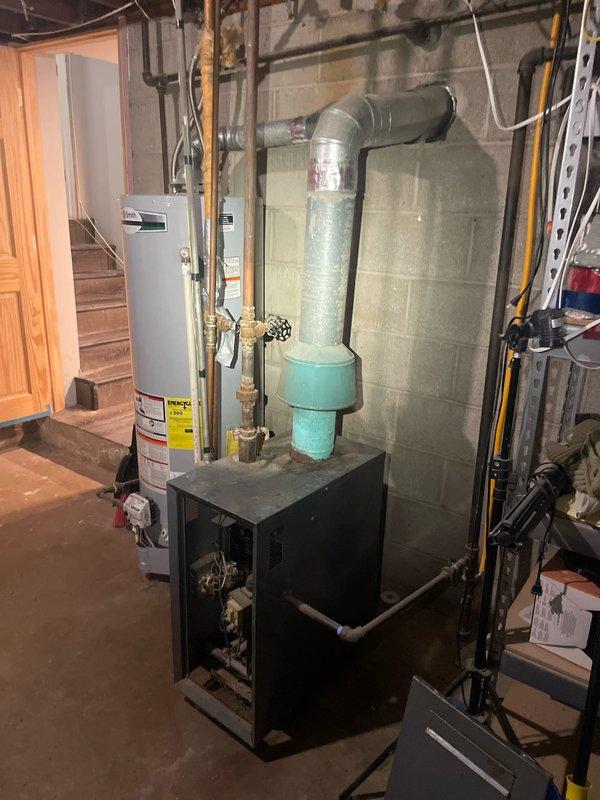 Inspected 15-year-old boiler system following customer complaint of strong metallic odor during operation. Visual examination revealed aged unit with visible rust on casing and deteriorating components. While system remains functional, the characteristic hot metal smell during operation indicates potential heat exchanger issues or component overheating. Recommend replacement of existing boiler unit to prevent further deterioration and eliminate odor concerns.