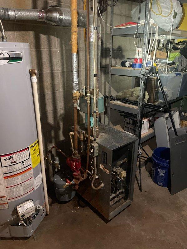 Inspected 15-year-old boiler system following customer complaint of strong metallic odor during operation. Visual examination revealed aged unit with visible rust on casing and deteriorating components. While system remains functional, the characteristic hot metal smell during operation indicates potential heat exchanger issues or component overheating. Recommend replacement of existing boiler unit to prevent further deterioration and eliminate odor concerns.