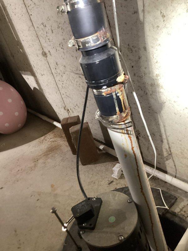 Responded to no hot water complaint at residence with two water heater system (standard unit and Integra model). Inspection revealed significant corrosion and rust on vertical pipe connections with failing rubber couplings. Replaced deteriorated components and restored hot water service to the property.