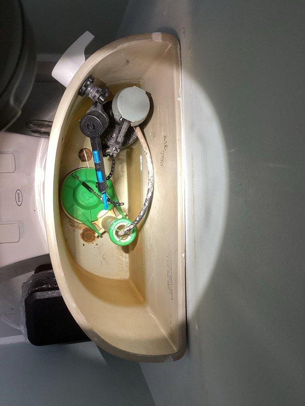 Responded to service call for toilet requiring wax ring replacement. Inspected interior tank components and found functional flush valve assembly with some mineral deposits. Completed wax ring replacement to resolve leakage issue at toilet base.