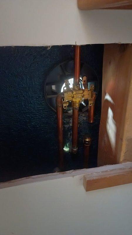 Inspected shower control valve system after customer reported issues with water flow control. Accessed plumbing wall to examine brass valve assembly and copper supply lines. Replaced damaged cartridge in the shower control valve to restore proper water distribution functionality.