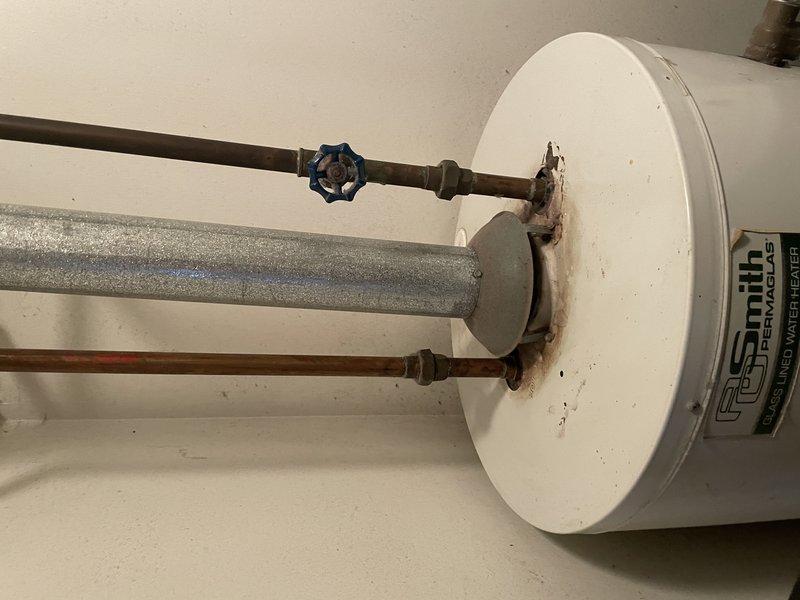 Conducted inspection of existing A.O. Smith water heater showing signs of corrosion at pipe connections with visible rust-colored staining. Discussed replacement options with customer, including tank vs. tankless models, and scheduled installation appointment for 10-12 timeframe as requested.