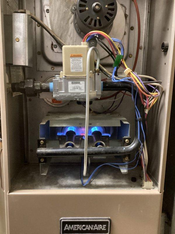 Responded to no heat call for 10+ year old American-Aire furnace. Diagnosed faulty gas valve and contaminated burners affecting combustion. Successfully replaced gas valve assembly and performed thorough burner cleaning to restore proper heating function.