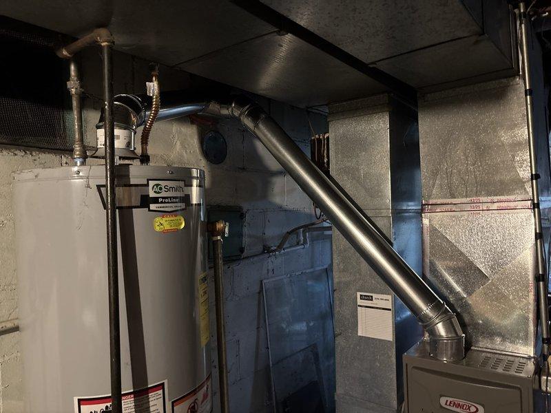 Successfully installed a chimney liner for the HVAC system, properly connecting the Lennox furnace and A.O. Smith ProLine water heater to the new ventilation components. All metal ductwork and vent piping were secured with appropriate brackets, ensuring proper exhaust flow and system safety.