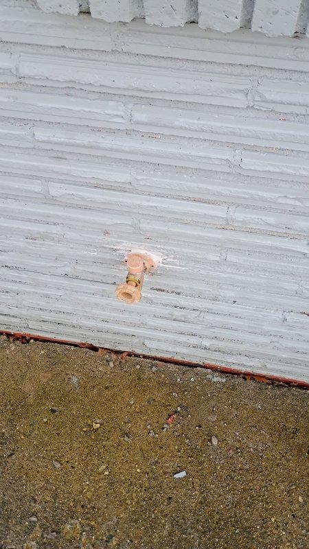 Accessed outdoor faucet through basement ceiling access panel to diagnose replacement needs. Inspected copper supply line connection to exterior wall-mounted hose bibb. Replaced deteriorated outdoor faucet with new unit, ensuring proper sealing at exterior wall penetration and secure connection to existing copper supply line.