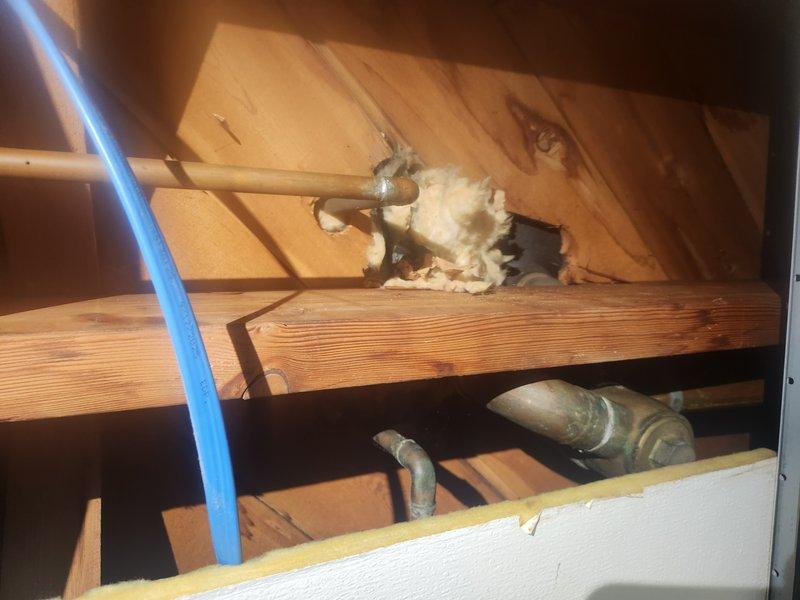 Conducted on-site assessment of bathroom for tub and shower removal and insert installation. Observed existing bathroom layout including toilet, fixtures, and plumbing connections. Discovered damaged insulation and inspected accessible plumbing infrastructure behind wall, noting current copper pipe configuration that will require modification during installation. Customer advised that while plumbing work can be completed, separate contractor would be needed for any drywall and flooring modifications.