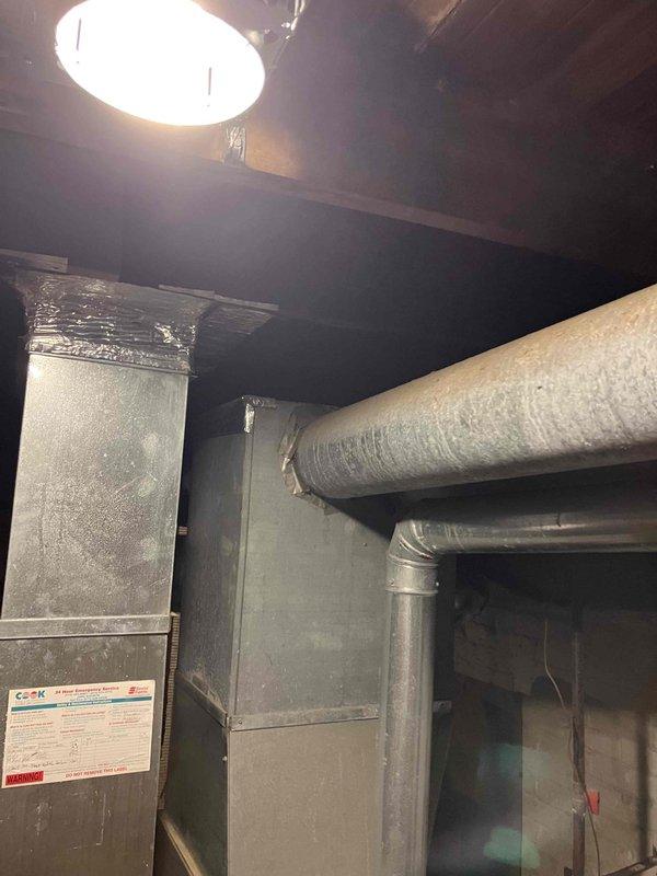 Inspected non-operational furnace after basement flooding incident. System appears to have sustained water damage with no airflow through vents and home temperature at 52°F. Conducted visual assessment of ductwork, air handler components, and insulated piping. Recommended complete furnace replacement due to water damage and safety concerns.