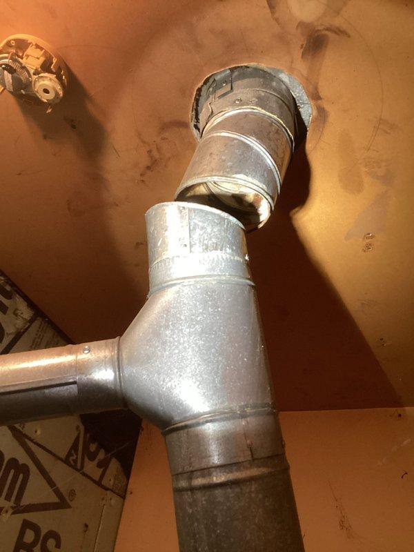 Performed diagnostic on non-operational furnace after gas company identified rusted vent pipe as possible cause. Inspection of the galvanized ductwork system revealed significant deterioration at connection points and T-junction. Determined that compromised ventilation system was causing improper exhaust, triggering safety shutdown of the aging heating unit.
