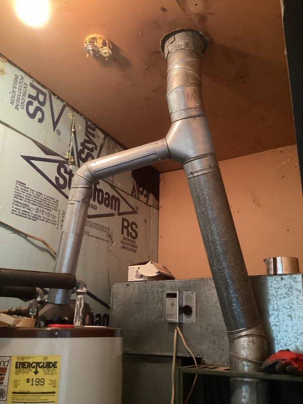 Performed diagnostic on non-operational furnace after gas company identified rusted vent pipe as possible cause. Inspection of the galvanized ductwork system revealed significant deterioration at connection points and T-junction. Determined that compromised ventilation system was causing improper exhaust, triggering safety shutdown of the aging heating unit.