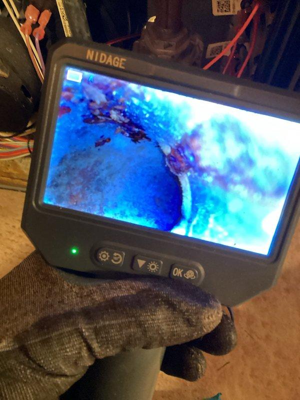 Diagnosed 15-year-old furnace with limited heat output using visual inspection and digital endoscope. Identified significant corrosion and wear in internal components, particularly around the blower motor assembly and electrical connections. Performed maintenance service on accessible components to restore temporary functionality while recommending system replacement due to age and deterioration.