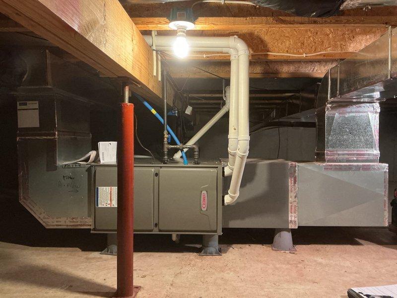 Successfully installed a Lennox ML196HF045 furnace with T4 thermostat in basement utility area, connecting to existing return air filter system. Completed proper installation of PVC drain pipe with elbow joint beneath unit and connected all necessary ductwork. Unit mounted on stabilizing feet and secured with proper ventilation according to manufacturer specifications.