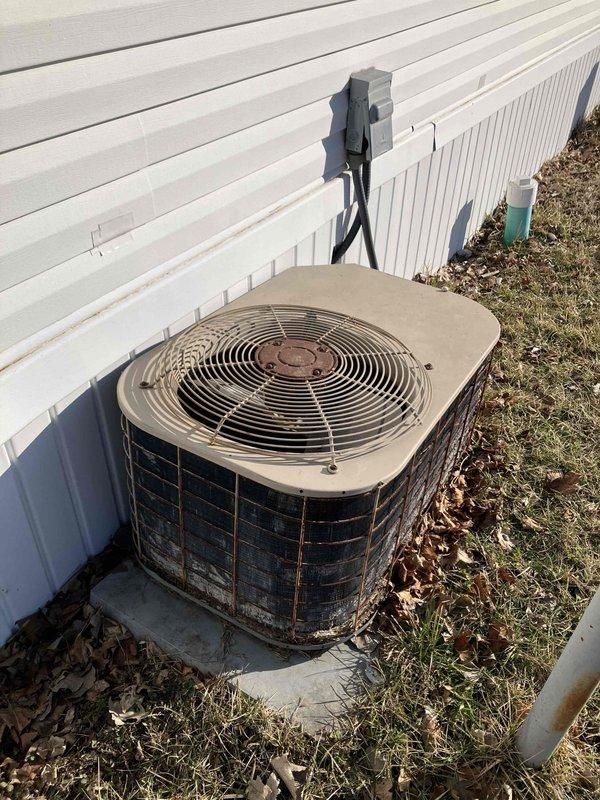 Conducted a comprehensive evaluation of the residence's aging HVAC system, including inspection of the weathered outdoor condenser unit showing visible corrosion and dirt accumulation on the coil sections. Assessment included examination of the existing Honeywell thermostat functionality and current system performance to determine optimal replacement options for the client's heating and cooling needs.