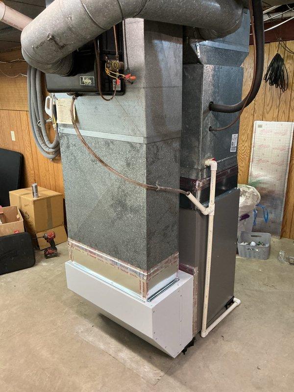 Successfully installed a Lennox ML196UH090XE48C furnace with 1610 media filter in basement utility area. Properly connected white PVC drain lines and exhaust/intake piping, secured electrical wiring with zip ties, and reconnected to existing thermostat. Installation completed with organized piping connections and proper ductwork integration.