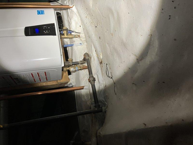 Performed scheduled A/C tune-up service with customer-provided 16x25x3 filter. Inspected tankless water heater installation in utility area, verifying proper connection of copper piping, brass fittings, and operational status of digital control panel. System functioning as designed with no issues identified.