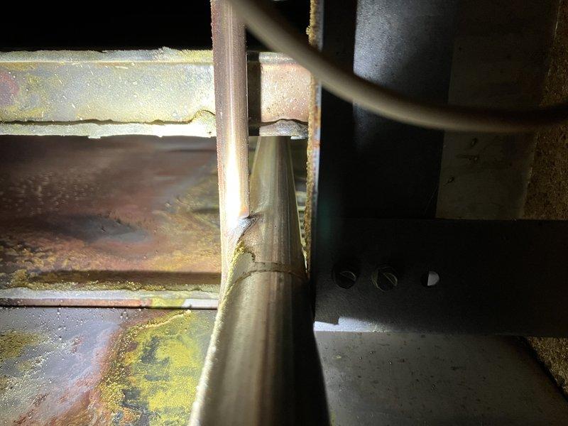 Diagnosed furnace with carbon monoxide leak and no heat production. Inspection revealed significant corrosion on heat exchanger with visible cracks and damaged metal components. Determined gas control valve failure was preventing proper heating operation; replacement valve installed and system tested for safe operation.