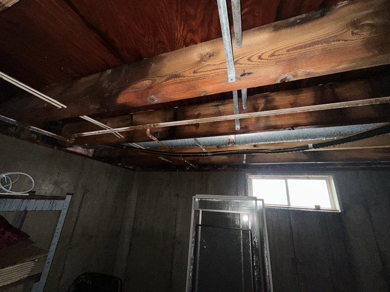 Conducted comprehensive inspection of property with frozen and burst pipes. Documented extensive water damage to interior wall structures, with visible mold/mildew growth on wooden framing and surrounding surfaces. Assessment revealed compromised plumbing components including affected PVC drain pipes and copper supply lines, with photos taken for insurance documentation purposes.