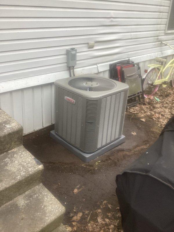 Completed installation of Lennox ML13KC1-030 air conditioning system with Mobile Home Coil. Unit was properly positioned on concrete pad adjacent to residence with electrical disconnect mounted on exterior wall. Existing thermostat was reused as specified in work order, and system was tested for proper operation.