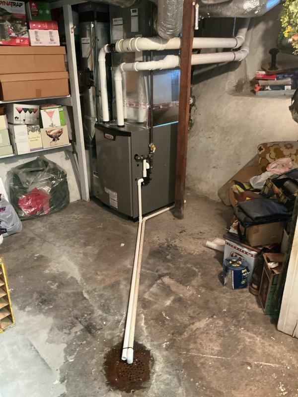 Successfully installed new Lennox EL297UH090XV48C high-efficiency furnace with T6 thermostat in basement utility room. Connected white PVC exhaust venting through ceiling and properly installed condensate drain line to existing floor drain. Reconnected system to existing air filter and verified proper operation of all components.