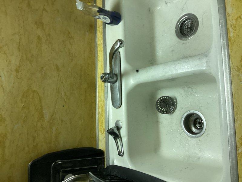 Performed main drain cleanout service in basement utility area with visible PVC piping system. Cleared blockage in the drainage system affecting the kitchen sink. Restored proper water flow and drainage functionality to the plumbing system.