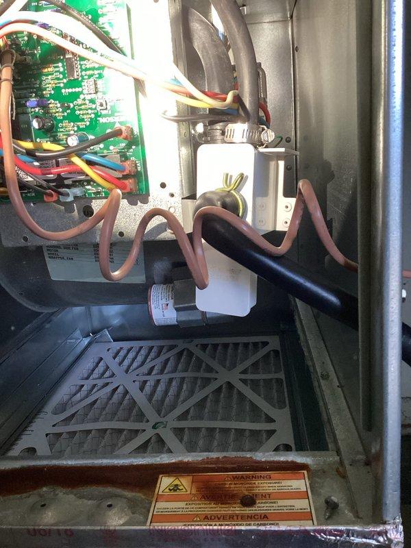 Responded to callback for water leak issue in HVAC system. Upon inspection, discovered condensate drain line was clogged and causing water to back up into the furnace area. Cleared blockage in drain line, checked circuit board connections for water damage, and verified all components were functioning properly after repair. System now operating correctly with no signs of leakage.