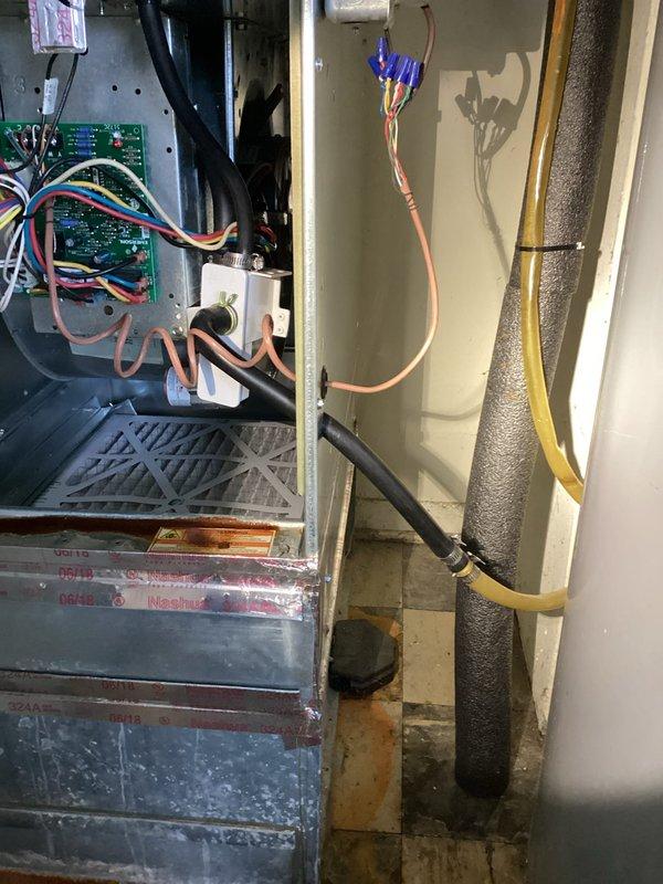 Responded to callback for water leak issue in HVAC system. Upon inspection, discovered condensate drain line was clogged and causing water to back up into the furnace area. Cleared blockage in drain line, checked circuit board connections for water damage, and verified all components were functioning properly after repair. System now operating correctly with no signs of leakage.