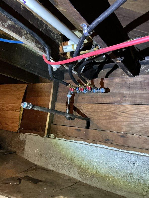 Completed re-piping of gas lines from meter to multiple appliances in basement utility area. Cleaned threads and resealed all fittings at connection points, including manifold assembly with color-coded connectors. Performed comprehensive pressure test upon completion to verify system integrity with zero leaks detected.