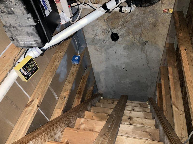 Performed comprehensive inspection of residential plumbing systems. Identified non-functional battery backup on sump pump, self-flushing toilet with significant tank corrosion/mineral buildup requiring replacement, and outdoor spigot shutoff valve needing replacement. Documented basement access and aging plumbing infrastructure with photographic evidence.