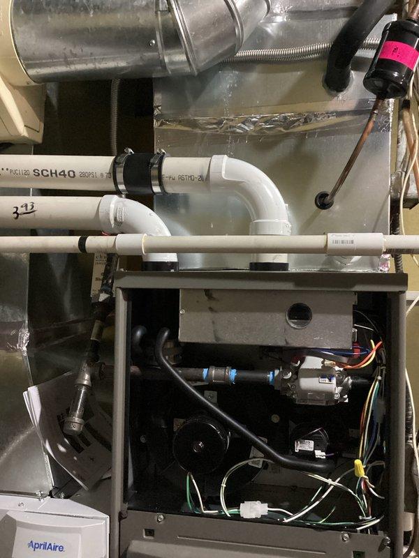 Responded to callback for no heat issue on recent installation. Inspected exterior condensate line configuration and PVC venting on Genesis unit. Found improper installation of AprilAire humidifier components and corrected wiring connections at the furnace. System now operating normally with proper heat output.