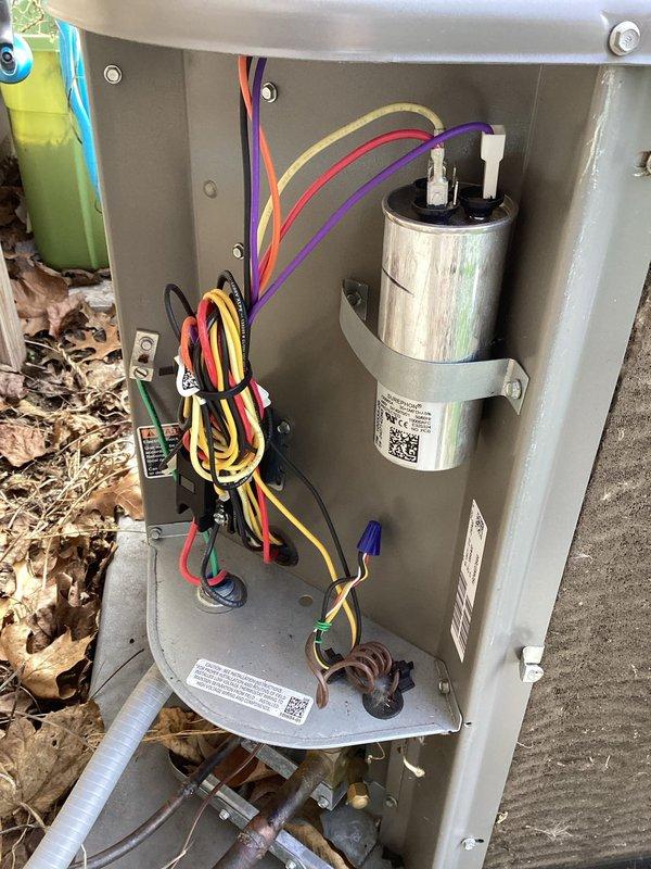 # HVAC Maintenance Completed

Performed comprehensive planned maintenance on Bryant outdoor condensing unit as part of annual cooling system service. Conducted thorough visual inspection of all accessible components with access panel removed to verify proper operation and identify potential issues.

Inspected electrical system including capacitor, relay, and all wiring connections. Verified capacitor mounting and terminal connections were secure. Confirmed proper wire management with zip ties maintaining organized routing of orange, red, yellow, purple, blue, and black conductors throughout unit. Checked relay operation and mounting integrity.

Examined refrigerant line connections at copper tubing junction points for signs of leaks or deterioration. Inspected condenser coil fins and fan assembly through top grille. Assessed unit positioning on concrete pad and verified adequate clearance around equipment.

Replaced 14x25x1 air filter per maintenance schedule. Documented unit condition