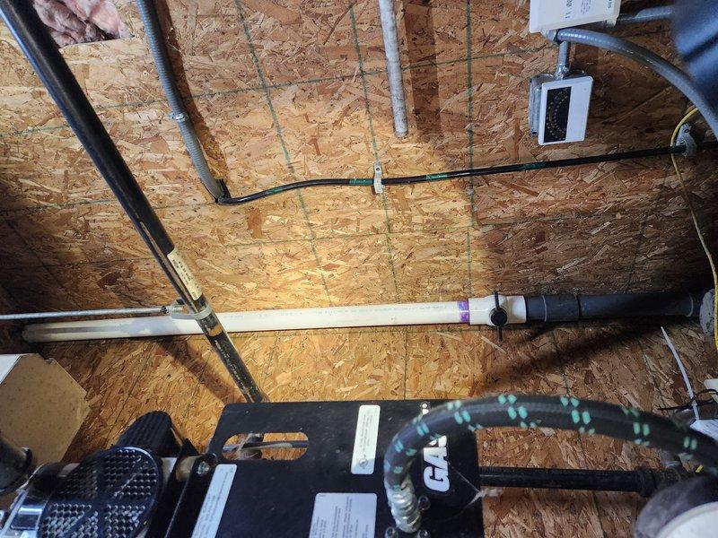 Responded to emergency plumbing call for fire-damaged burst pipe in attic space. Upon arrival, confirmed water supply had been shut off to prevent further property damage. Assessed 2-3 inch diameter pipe that had ruptured due to fire exposure, causing active water leak prior to shut-off. Documented extensive damage to piping system in crawlspace area near HVAC equipment and ductwork. Inspected surrounding PVC plumbing lines, gas connections, and mechanical systems for additional fire-related damage or compromised integrity. Photographed affected areas showing damaged pipe runs, exposed structural elements, and proximity to heating and ventilation components to document scope of repairs needed.