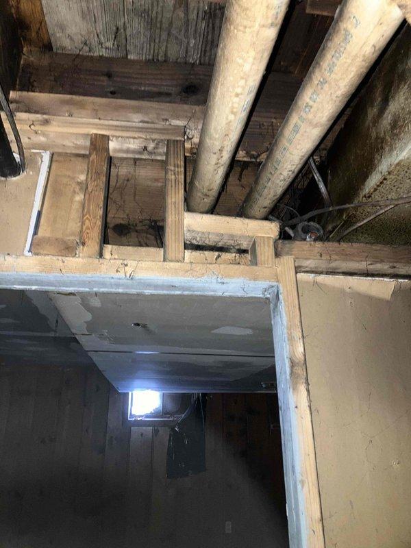 Conducted site assessment of existing HVAC system in crawlspace for restoration project requiring complete system replacement. Evaluated current air handler unit, supply plenum, flexible ductwork connections, and condensate drainage system. Documented deteriorated insulation on plenum box, aging flexible duct runs with compromised connections, and existing drip pan showing signs of corrosion and water damage. Inspected structural conditions including exposed floor joists, subflooring, and identified moisture-related issues on foundation walls that will require remediation prior to new equipment installation. Prepared comprehensive estimate for complete HVAC system replacement including new air handler, properly sized ductwork, updated plenum assembly, and condensate management system to meet current building codes and efficiency standards.