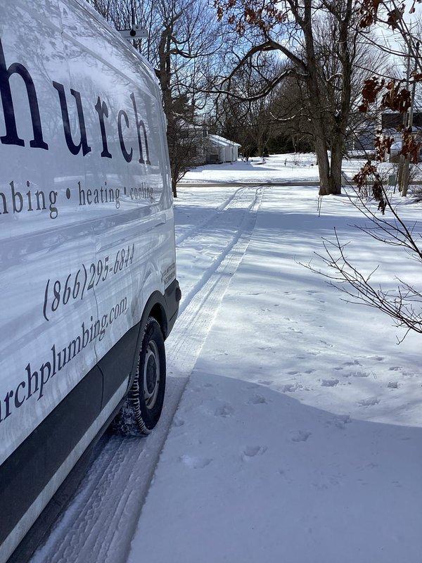 Completed water heater installation in residential basement utility area. Installed tanked water heater unit with proper copper supply line connections, flex connectors, and metallic venting system secured to wall with appropriate mounting brackets, ensuring all components meet code requirements for safe operation.