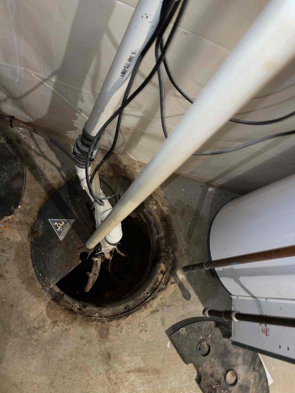 Responded to service call for dual sump pump system with one unit experiencing elevated water levels in basin. Upon inspection, diagnosed malfunctioning float switch on secondary sump pump preventing automatic activation. Primary pump operating normally with proper cycling and discharge. Tested secondary pump motor which functioned when manually activated, confirming float switch as sole failure point. Replaced defective float switch assembly, verified proper float travel and activation points, and tested complete pump cycle under load. Confirmed both pumps now operating correctly with appropriate water level maintenance in respective basins. System restored to full operational capacity with no flooding risk present.