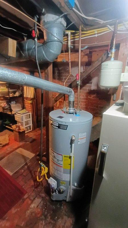 Installed new tanked water heater in basement utility area, including all necessary connections to existing copper supply lines and proper venting configuration. Connected expansion tank rated at 50 PSI to system and verified all pressure relief valves were functioning correctly. Inspected toilet reported as running constantly and performed necessary repairs to resolve continuous water flow issue.