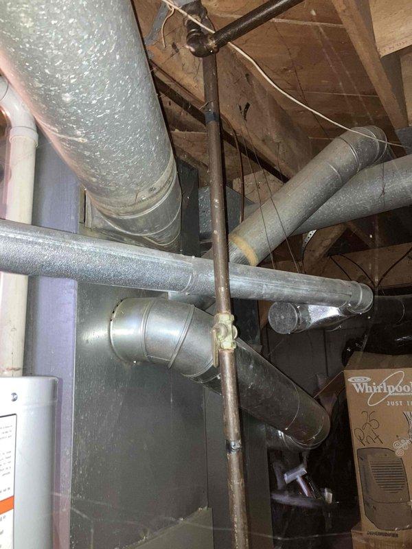 Responded to service call for 16-year-old heating system blowing room temperature air with thermostat set to 76°F but maintaining only 70°F. Performed diagnostic evaluation of furnace and HVAC system located in basement mechanical room. Assessed existing equipment condition, ductwork configuration including flexible metallic ducts and rigid metal distribution system in attic space, and overall system performance. Provided comprehensive estimate for complete HVAC system replacement due to age and inefficiency of current equipment.